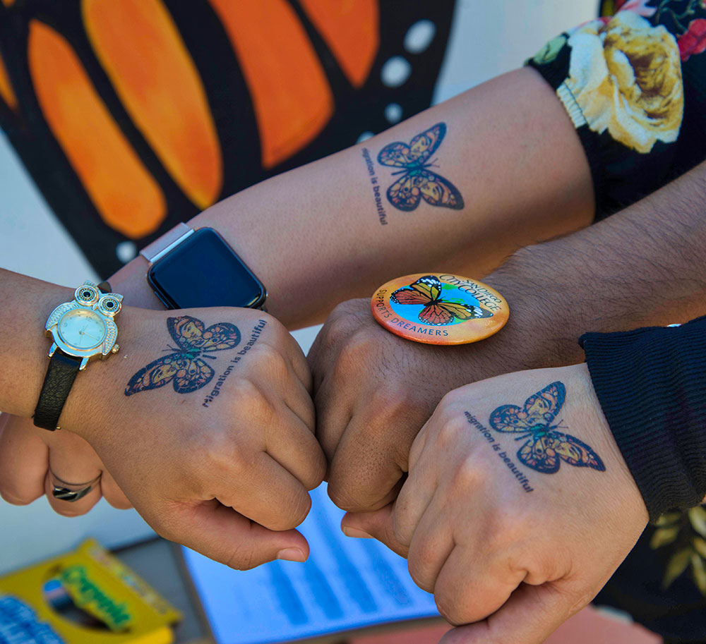 Butterflies tattooed on hands represent support for dreamers
