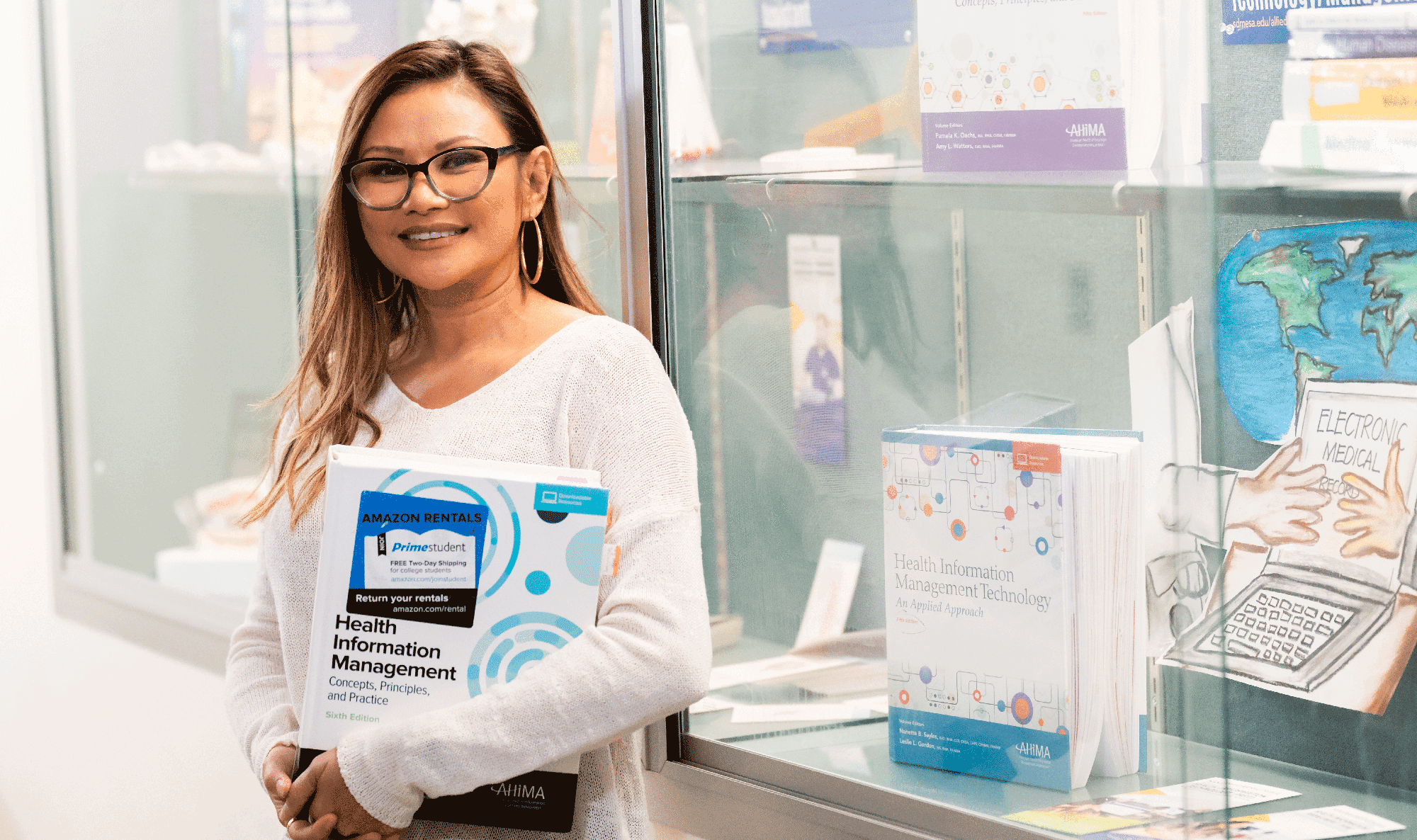 A student holds a binder for the health information management program