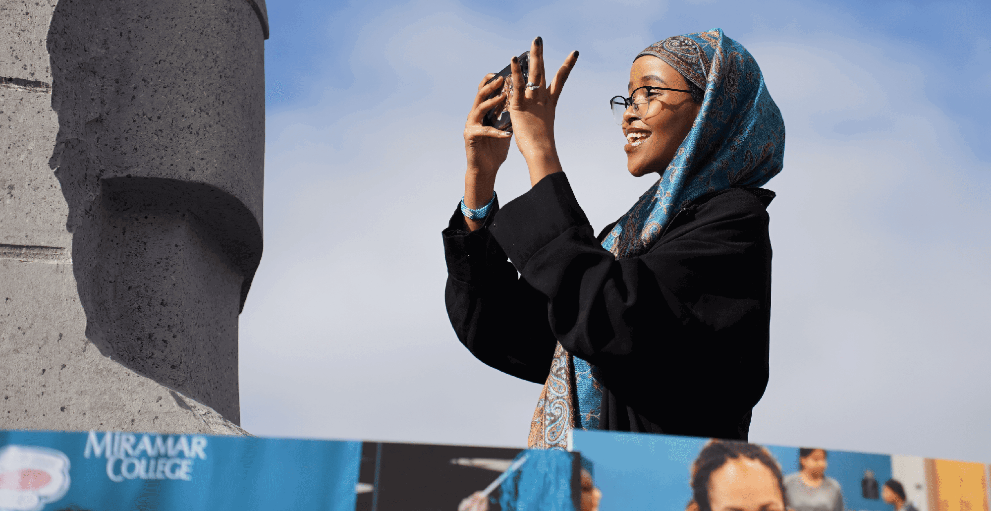 A student takes a picture of the float at the MLK parade