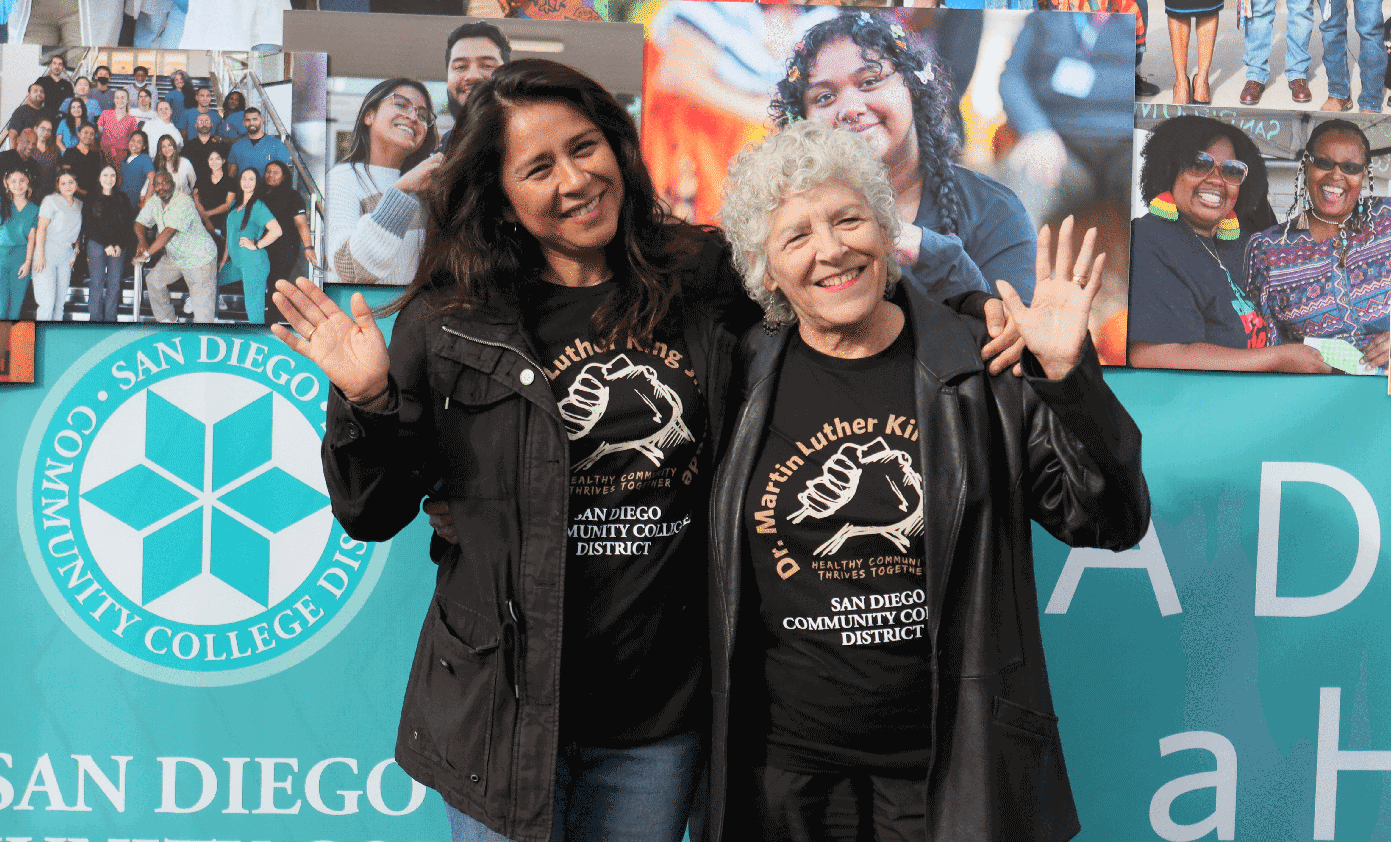 Two trustees wave at the MLK parade