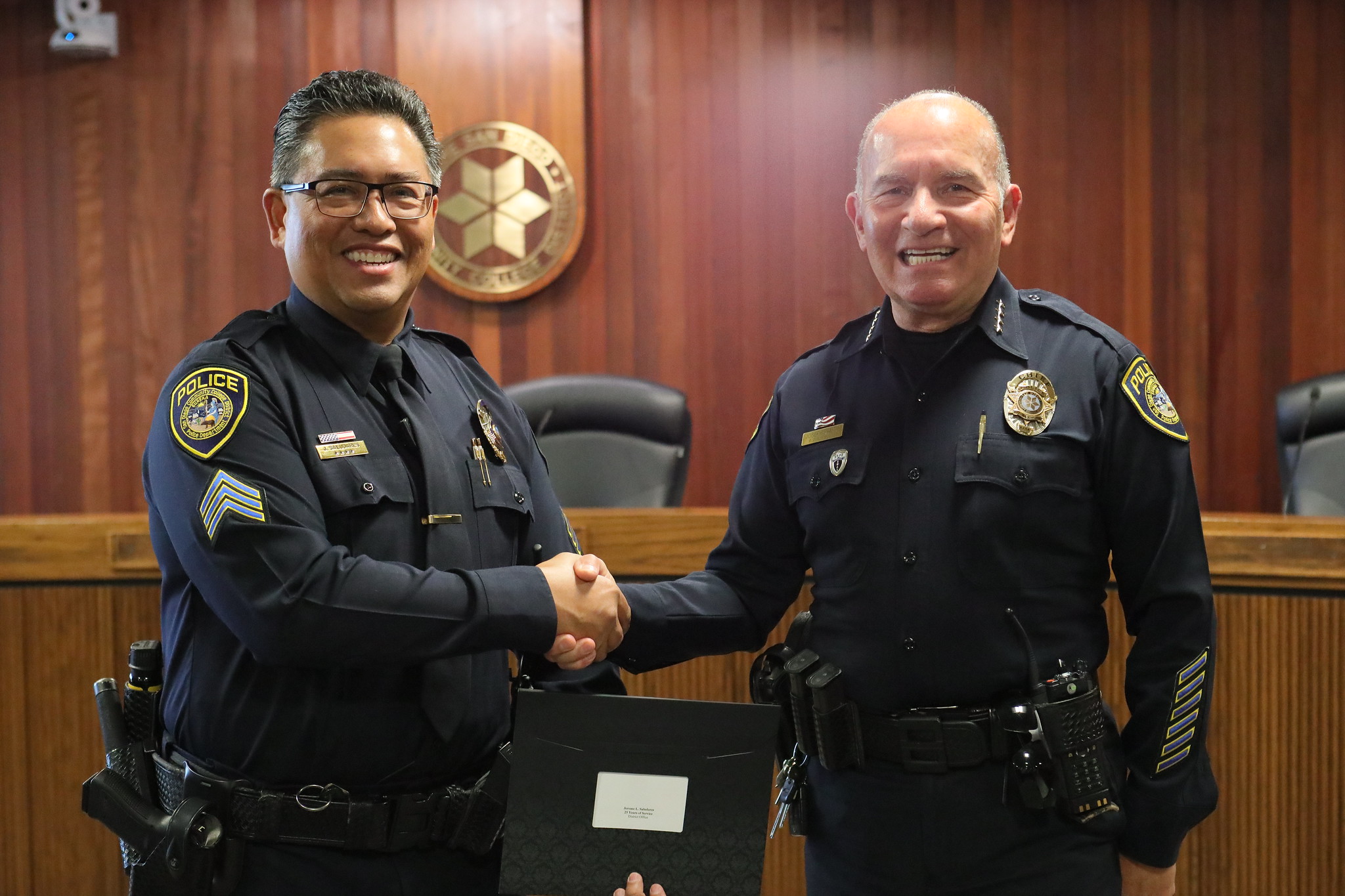 The chief shakes hands with an officer