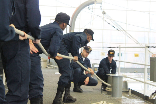 Sailors pull on a rope