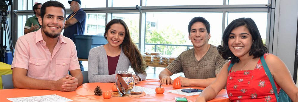 Four Mesa students sitting at a table