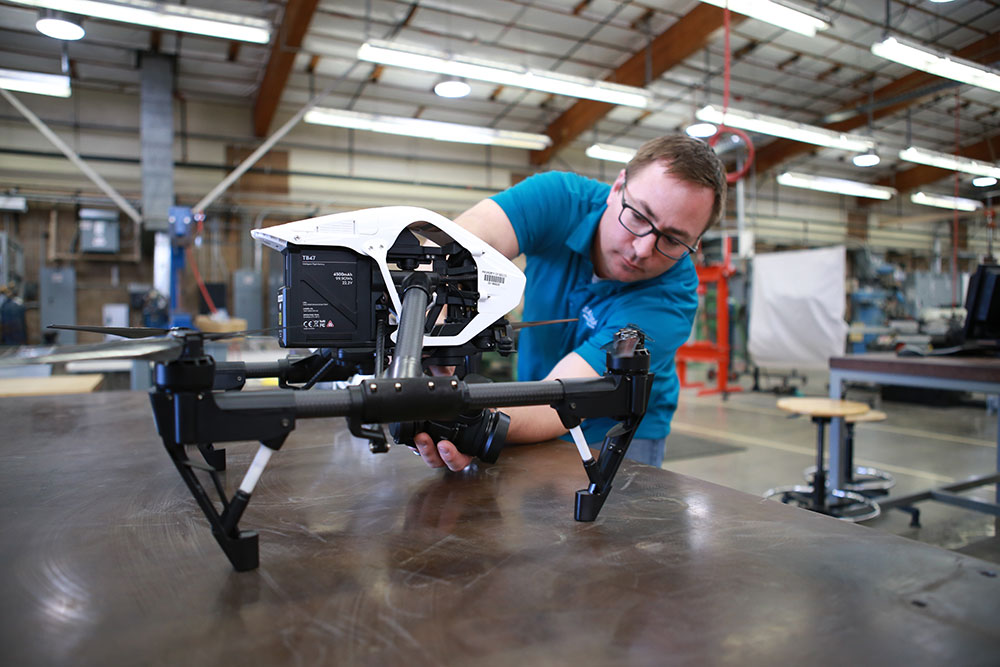 An instructor works on a drone at Miramar College