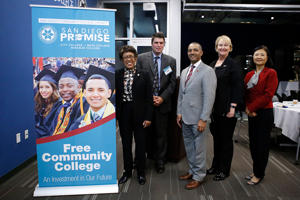 Chancellor and presidents next to a San Diego Promise sign
