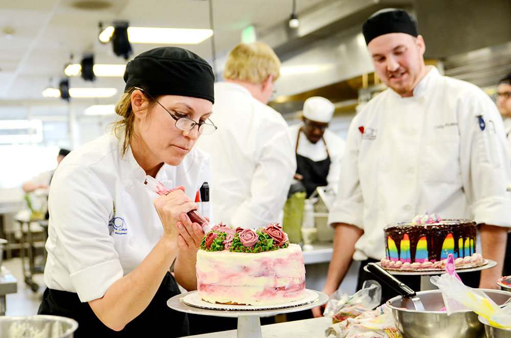 A student decorates a cake