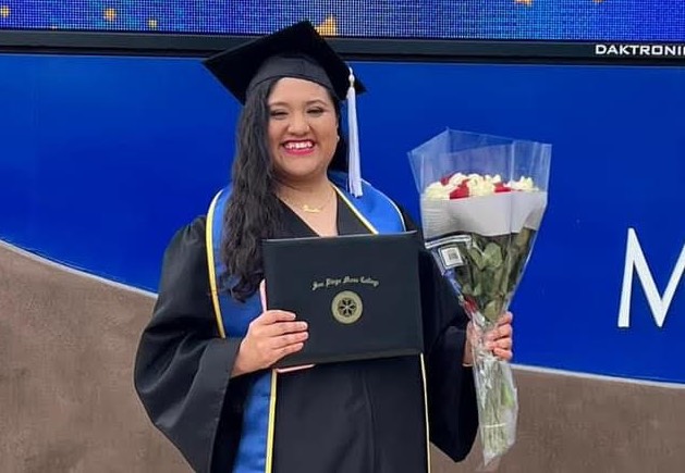 Rosalba Sanchez wearing cap and gown at Mesa graduation.