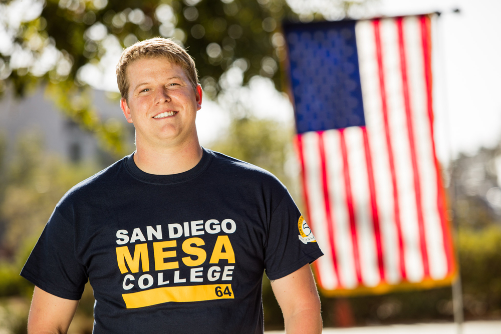 Mesa College student Calvin Dixon posed in front of an American Flag