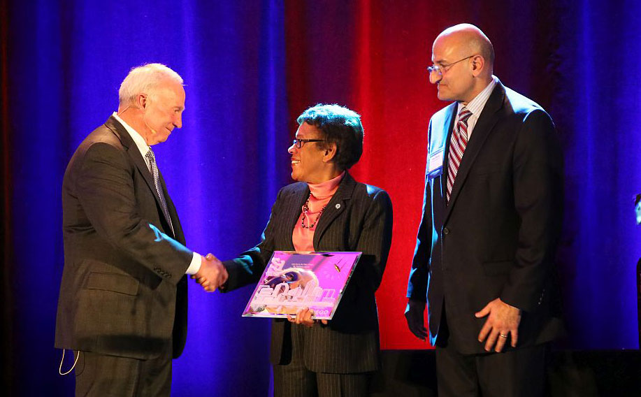 Jerry Sanders, Chamber President and CEO, and Sam Attisha, Vice President of Business Development and Public Affairs for Cox Communications, present the “Moving San Diego Forward” award to SDCCD Chancellor Constance M. Carroll.