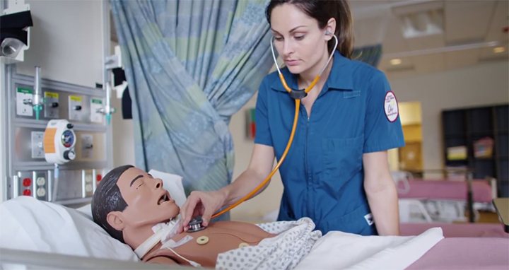 A nursing student uses a stethescope