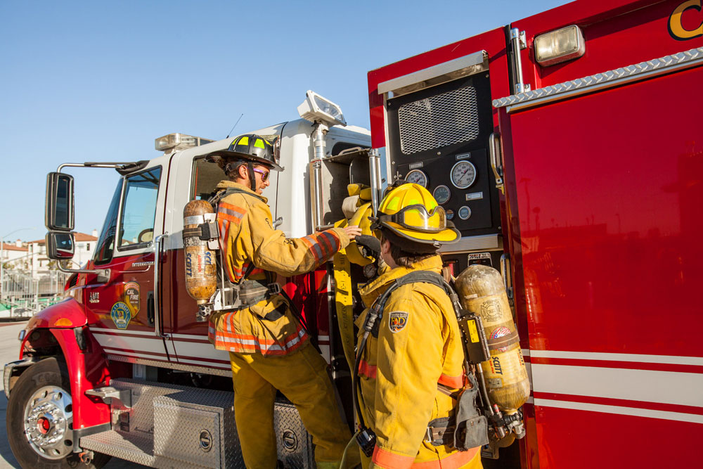 firefighting trainees near a fire truck