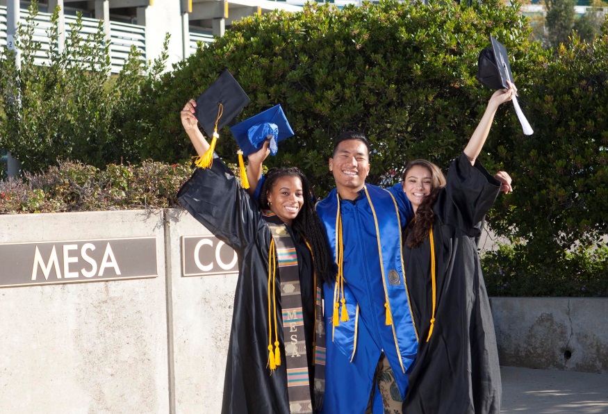 Three graduates in caps and gowns at mesa college