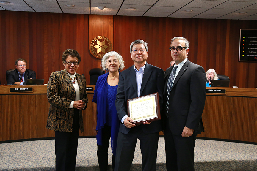 Owner of K&Z Cabiniet Company Dennis Chan is awarded for his company's work on district construction projects. From left, SDCCD Chancellor Constance M. Carroll, Board of Trustees President Maria Nieto Senour, Chan, and Vice Chancellor of Facilities Management Christopher Manis.