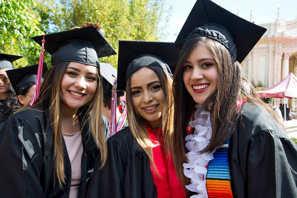 Three female graduates at City College commencement 2017