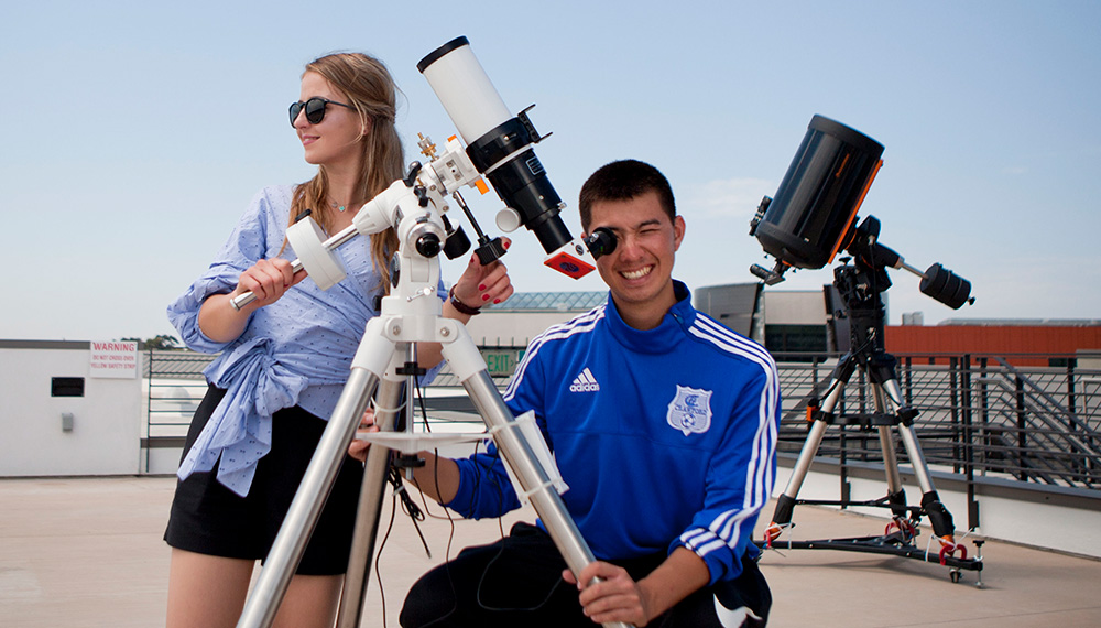 Miramar College students using a solar telescope on the roof of the college’s Science Building. 