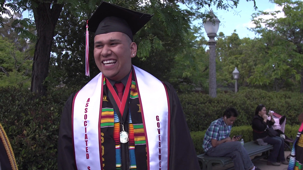 City College student Ignacio Hernandez in graduation regalia