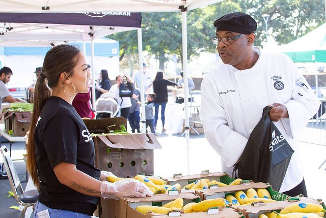 Two workers at the farmers market