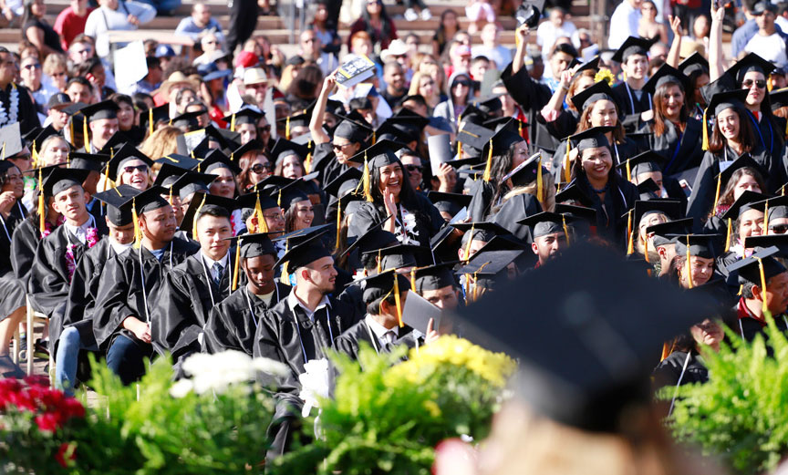 A sea of graduates in caps and gown wait for commemencement to begin