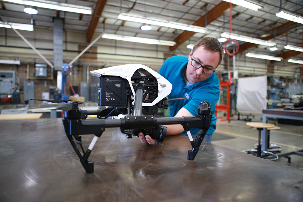 An instructor prepares a drone