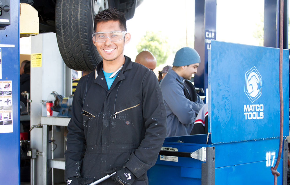 Humberto Perez in uniform at an auto shop