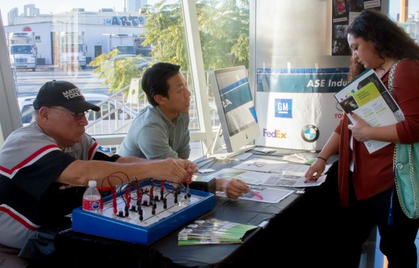 Two staff members talk to a potential student at last year's open house