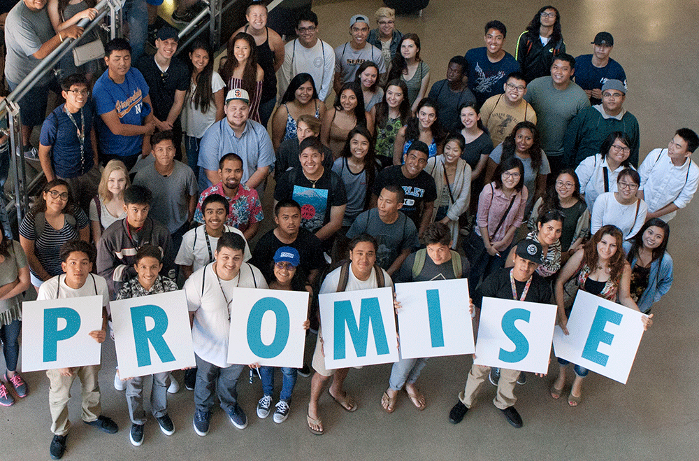 Promise students in a group holding up letters spelling promise