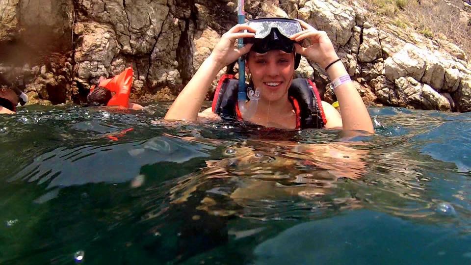 A student snorkeling during a study abroad trip