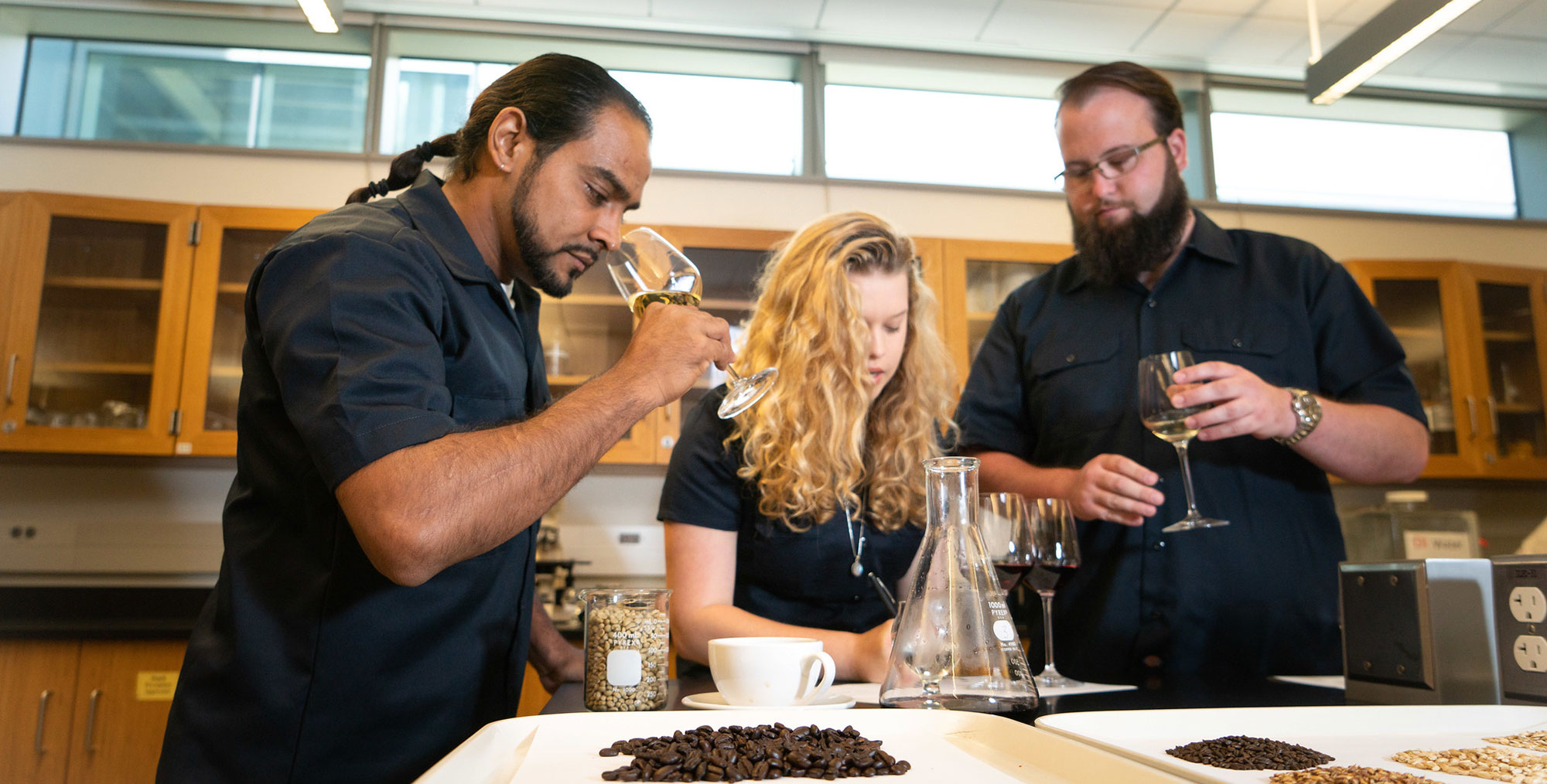 3 students smell wine in the fermentation program at mesa college