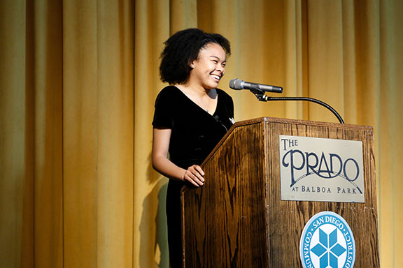 Aleah Jarin speaks at a podium at the honors reception