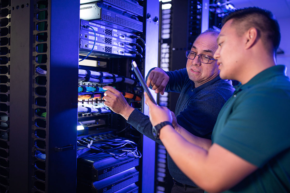 A student and instructor working on a server