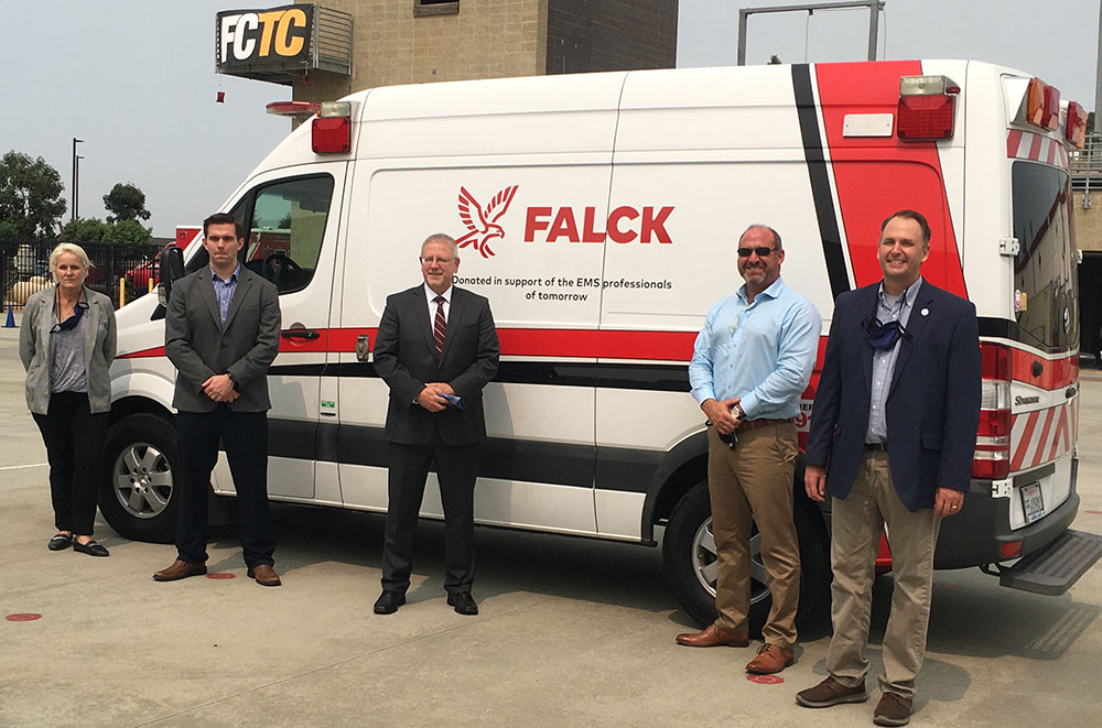 Miramar College President Wes Lundburg (center) and Dean of Public Safety Gail Conrad (far left) pose with members of Falck Emergency Services during an ambulance donation ceremony.