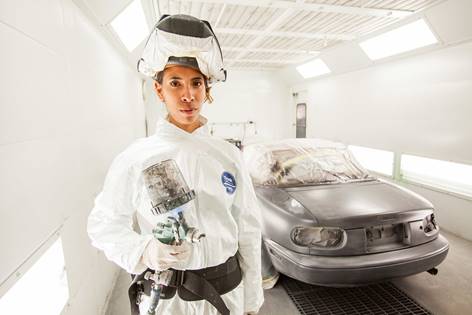 Student Elizette Garcia finishes a project inside Continuing Education's Auto Body and Paint Garage.