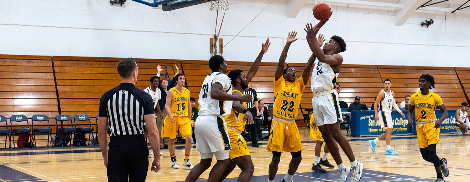 Mesa College basketball forward Cameron Hill (24) takes the ball to the hoop during a game against Grossmont College.