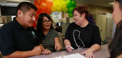 Human resources employees go over some paperwork