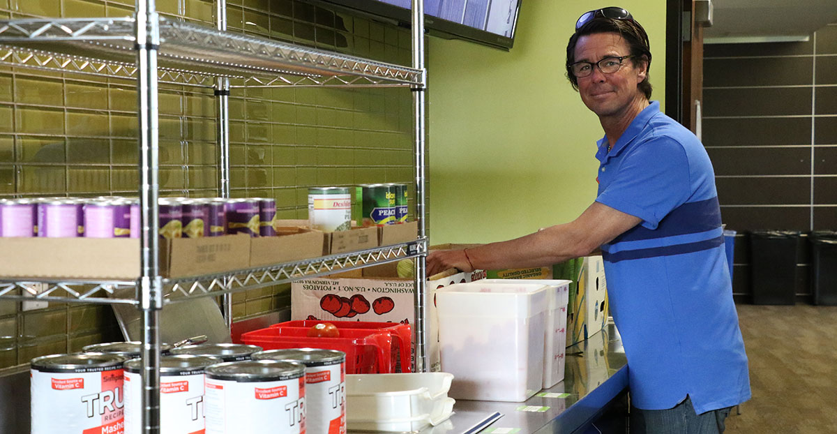 A volunteer stocks shelves at the Miramar pantry