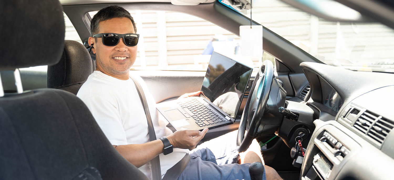 A San Diego Mesa College student at a laptop distribution event.