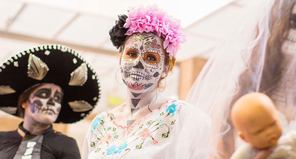 A woman with her face painted for Dia de los Muertos