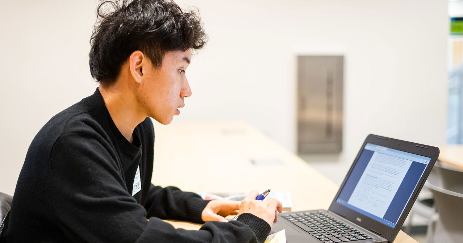 A student works on a laptop