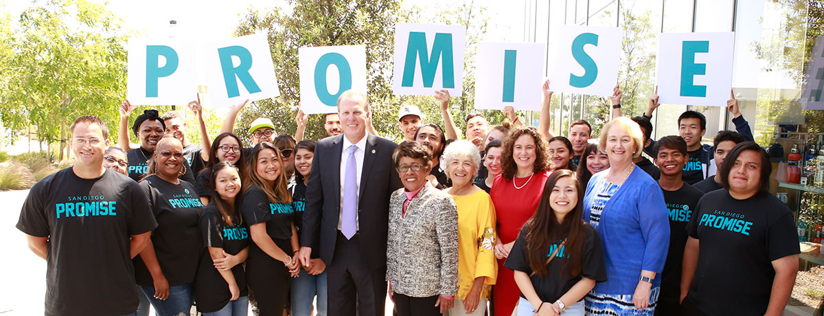 Leaders and students hold up letters spelling promise