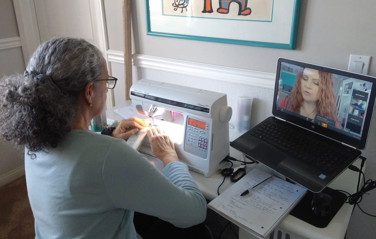 A San Diego Continuing Education student works on a project while watching a video taught by Clothing and Textile Arts Instructor Tammie Pontsler.