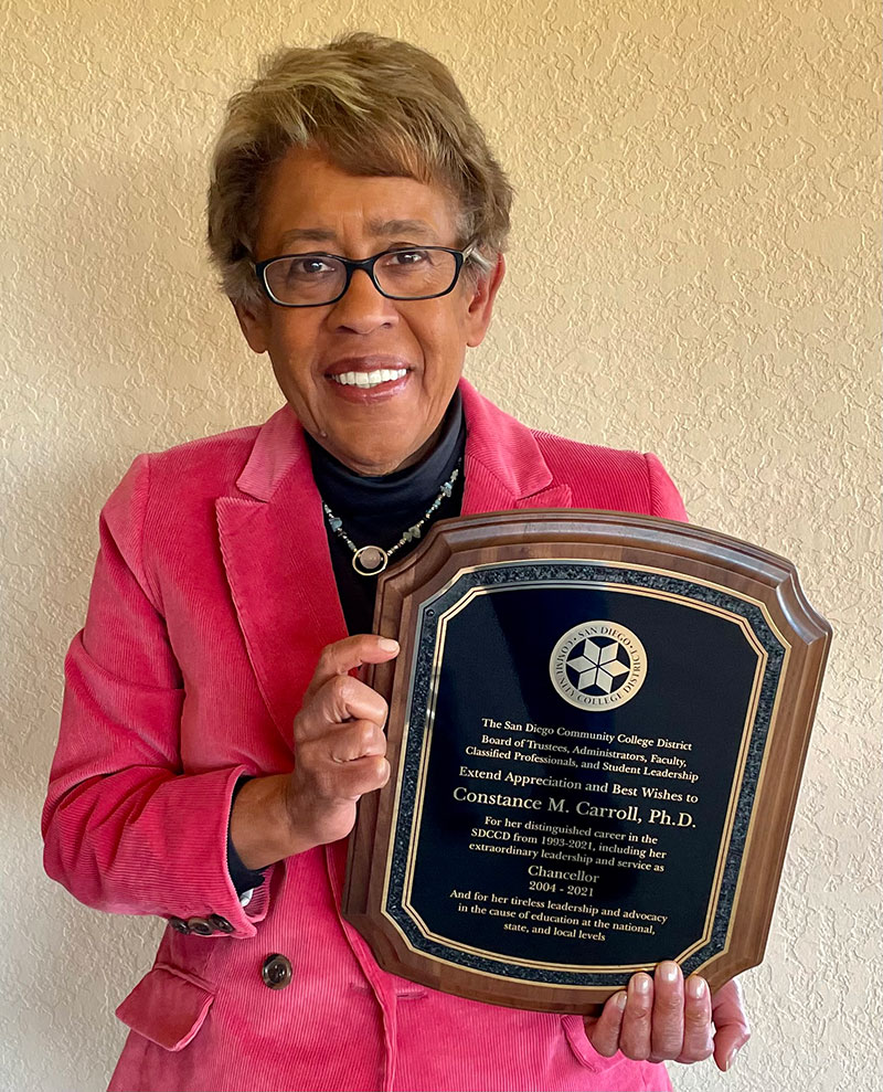 Constance M. Carroll holds a plaque