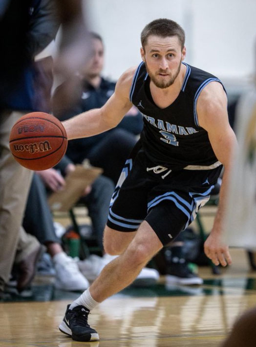 Cameron Barry runs and dribbles a basketball during a game