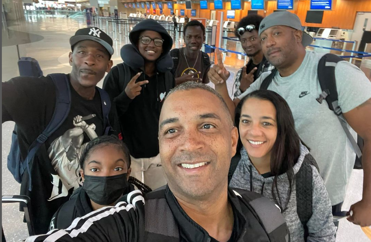 City College President Ricky Shabazz takes a selfie with City College students at the airport on their way to Ghana. 