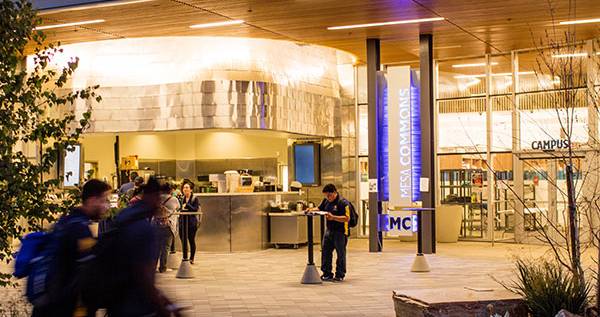 Students walking near Mesa Commons in the evening