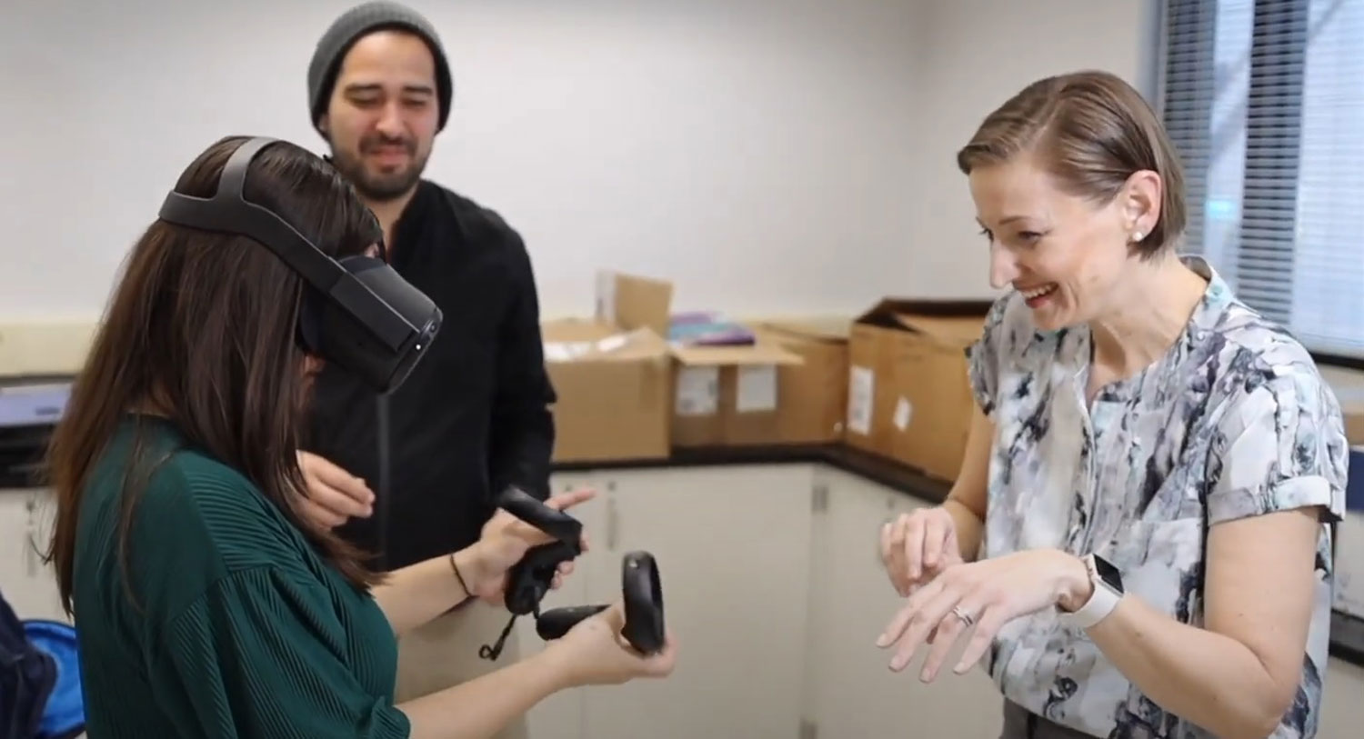 Tanya Hertz instructs a student on how to use virtual reality equipment