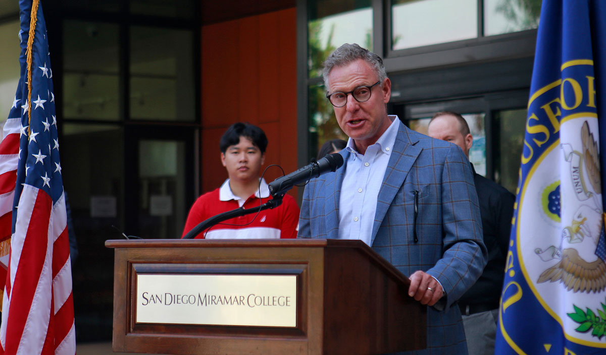 Rep. Scott Peters speaking at a podium.