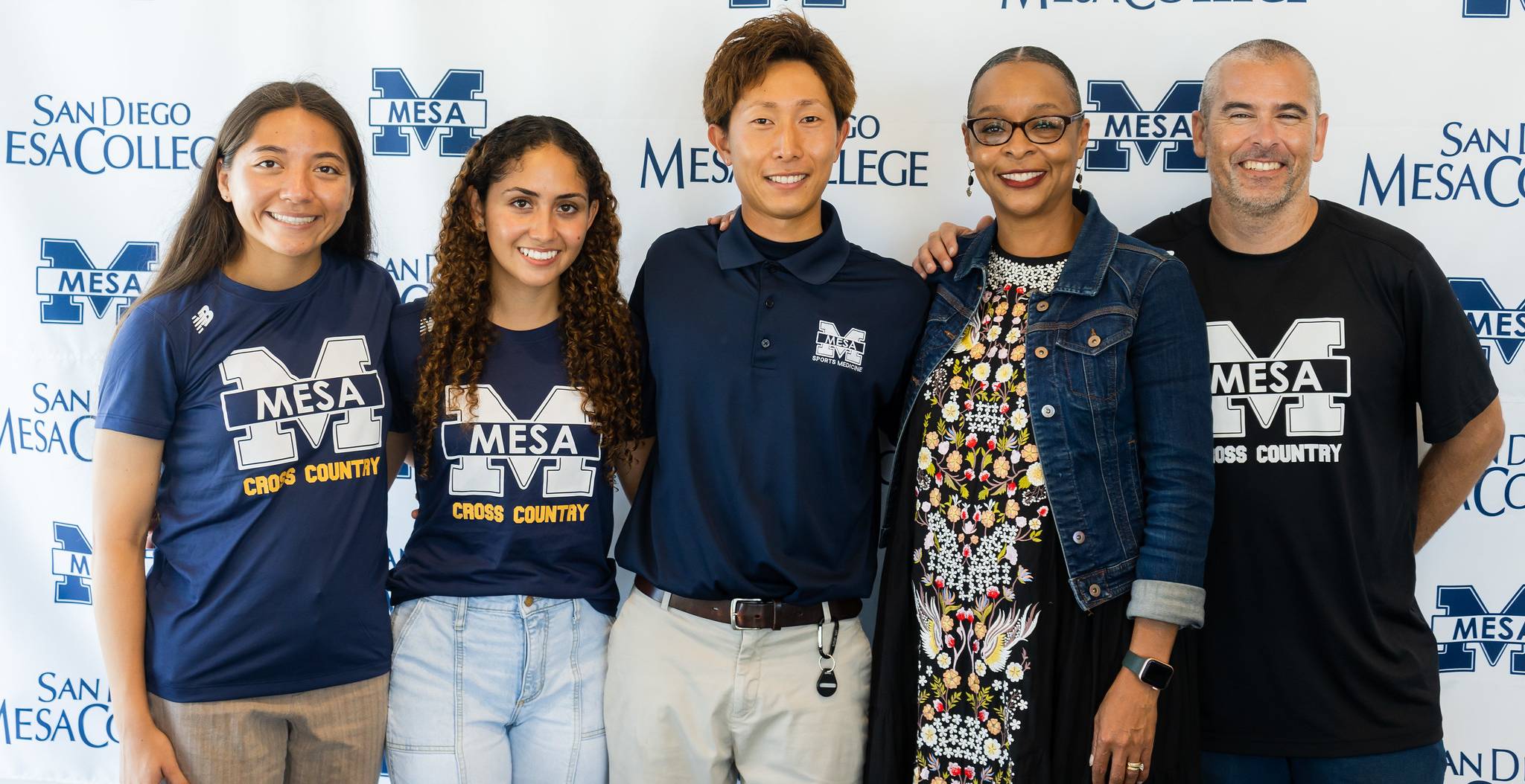 Yuki Matsuzawa, center, with Mesa College President Ashanti Hands, and two cross country students and a cross country coach.