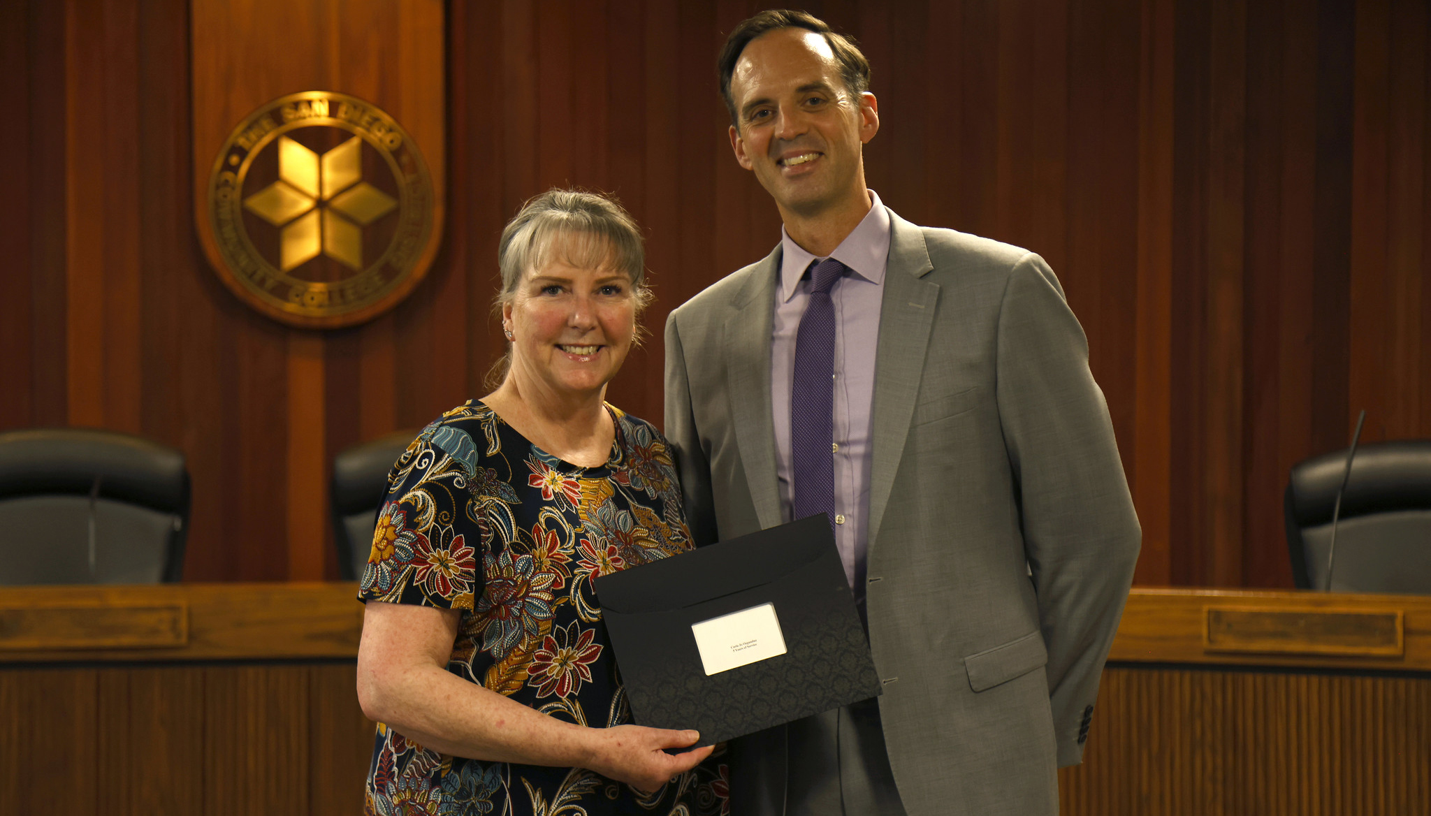 Gregory Smith hands out an award to an employee