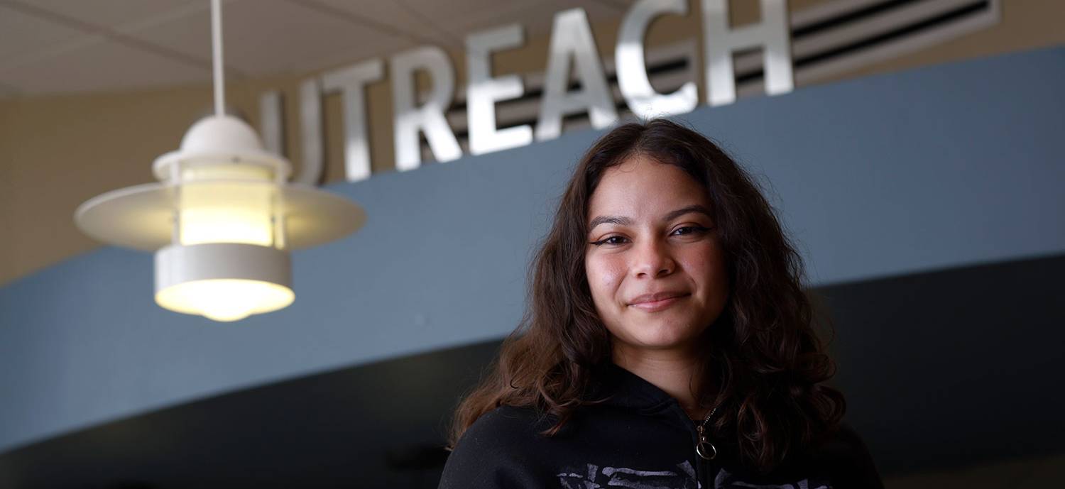 Breanna Hinojosa stands in front of the outreach office at Miramar College