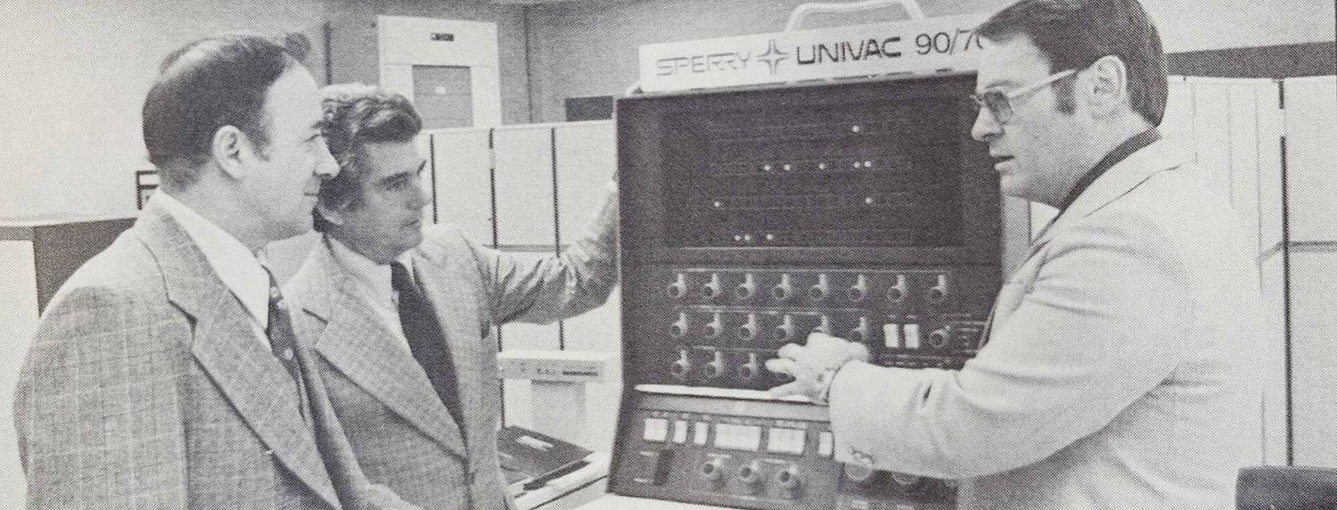 1978 computer In 1978 three men stand around a computer that is as tall as they are.